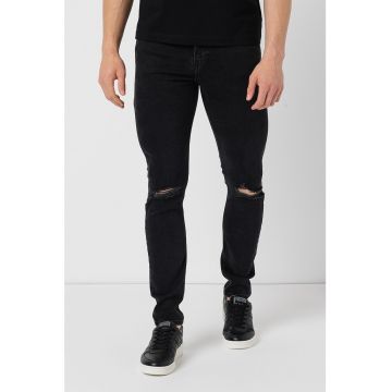 Blugi skinny cu rupturi decorative