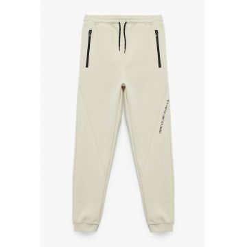 Pantaloni de trening cu buzunare cu fermoar si talie medie